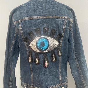 Size medium denim jacket with sequin eye in back